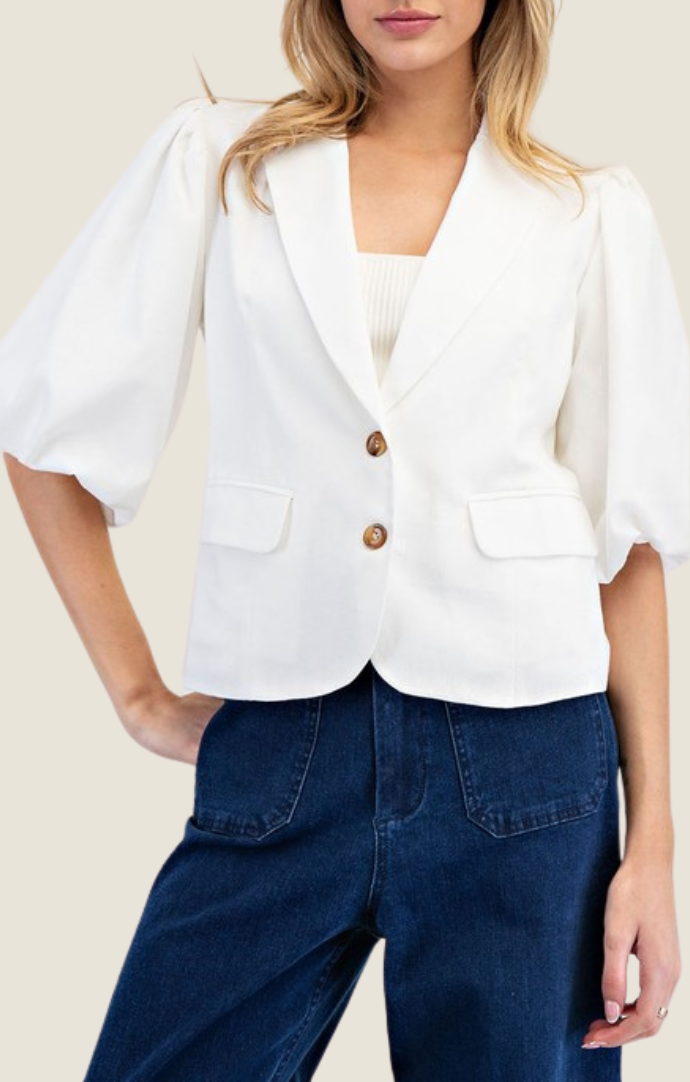 Adriel Off White Blazer Top featuring lapel collared v-neckline, double button down front, pinched shoulders, half bubble sleeves, and side flap pocket detailing