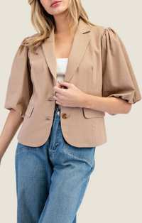 Adriel Coco Blazer Top featuring lapel collared v-neckline, double button down front, pinched shoulders, half bubble sleeves, and side flap pocket detailing