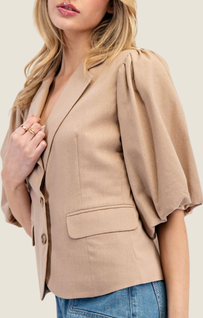 Adriel Coco Blazer Top featuring lapel collared v-neckline, double button down front, pinched shoulders, half bubble sleeves, and side flap pocket detailing