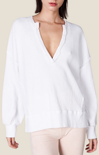 White waffle knit long sleeve top with open placket, balloon sleeves, and raw edge detailing MT210266-WHT